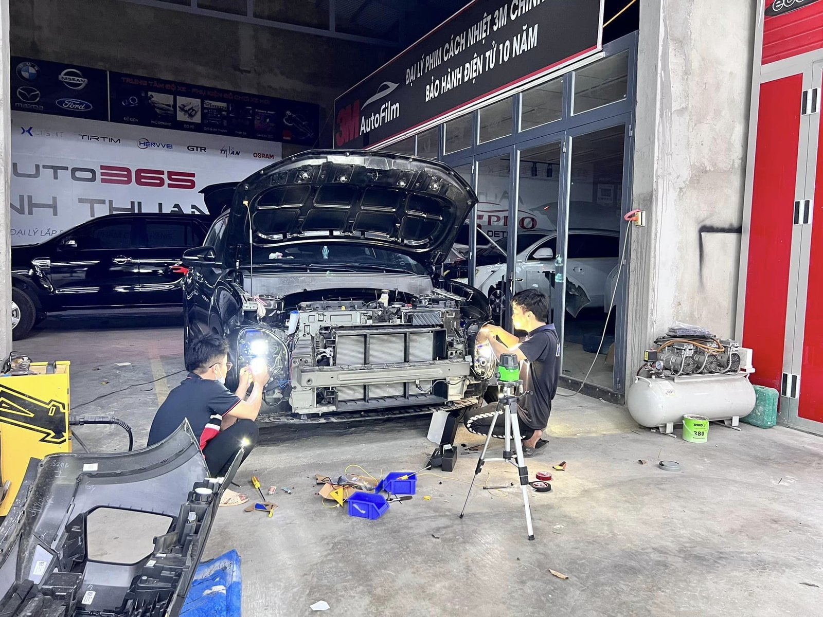 Nhân viên kỹ thuật đang kiểm tra hệ thống điện trên xe ô tô