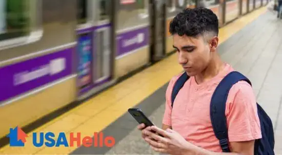 Man Looking At Immigration Guide On Phone At Subway Stop Man Looking At Immigration Guide On Phone At Subway Stop